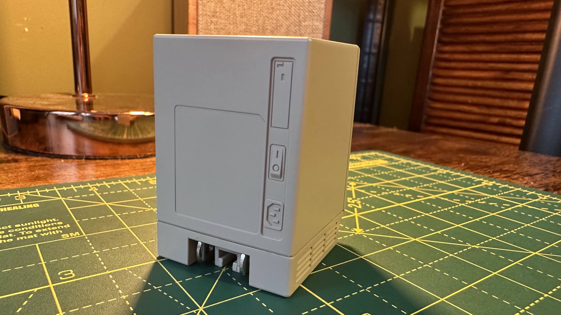 The Shargeek Retro 67 charger on a desk, which looks like a mini Macintosh computer.