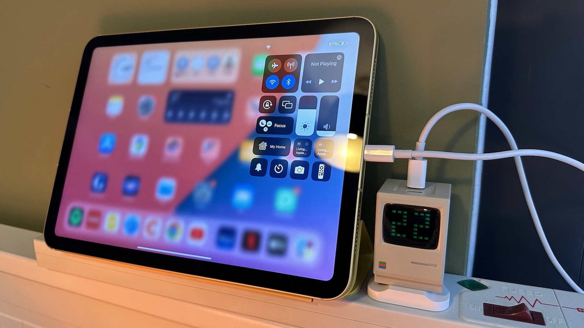 The Shargeek Retro 67 charger on a desk, which looks like a mini Macintosh computer.