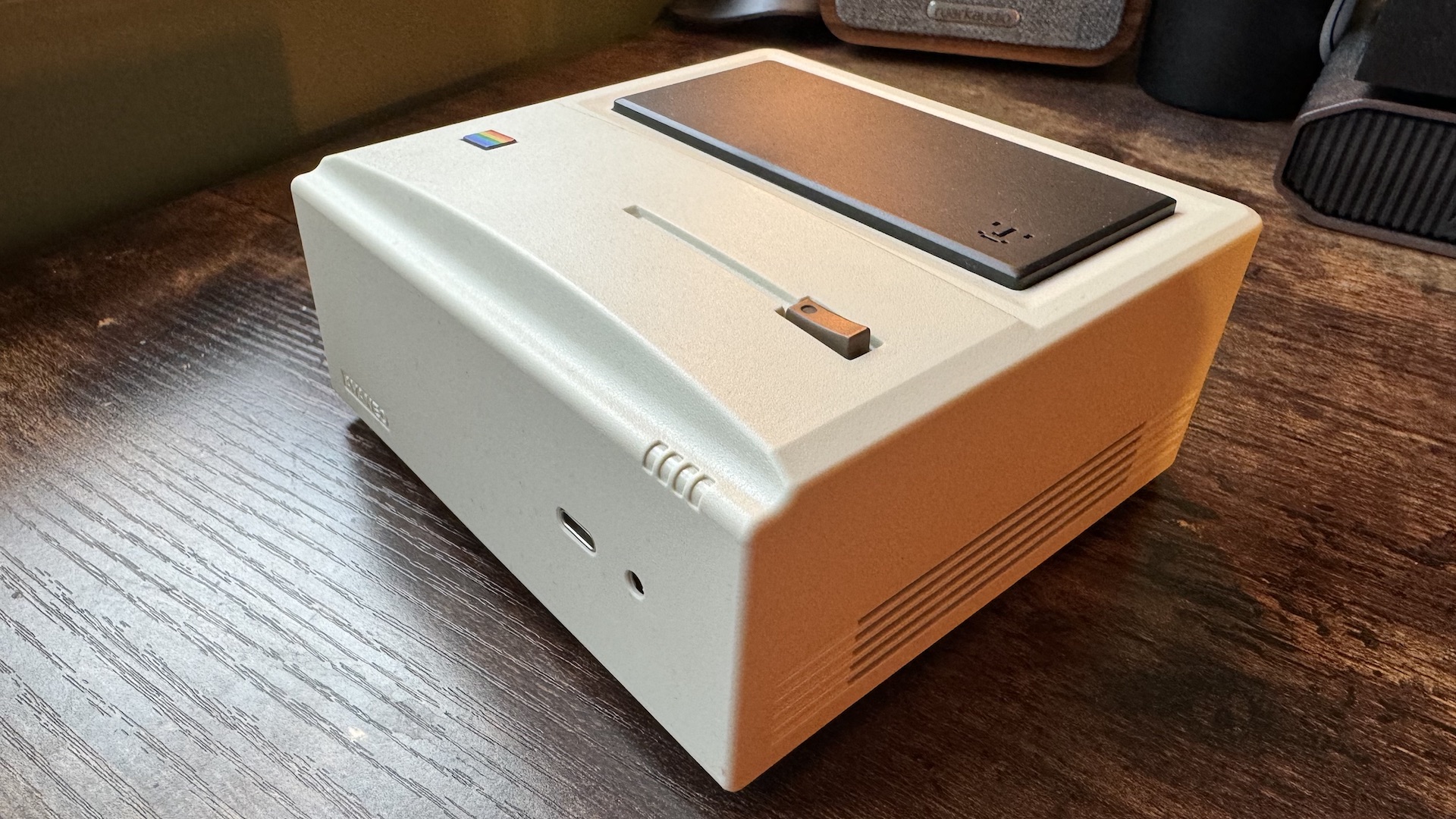 AyaNeo Retro Mini PC AM01 on a wooden home office desk